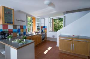 a kitchen with wooden cabinets and a counter top at House With Garden And Sea View in La Londe-les-Maures