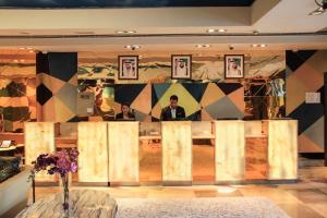 two men sitting at a table in a room at The Leela Hotel in Dubai