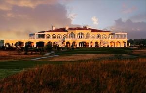a large yellow house on a golf course at Golf Villa in Lighthouse Golf & SPA Resort in Balchik