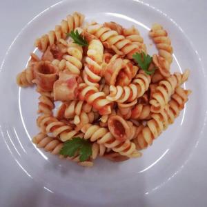 a plate of pasta on a white plate at Hotel Flora in Cesenatico