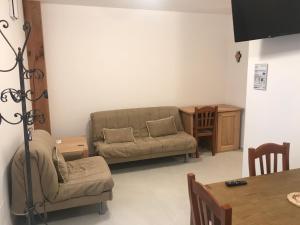 a living room with a couch and a table at PaeseMio Cervarezza di Bolzoni Maria Graziella in Cervarezza