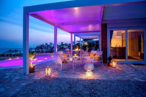 a patio with a table and chairs and lights at Terra Park Phalaris in Novalja