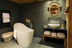 ein Badezimmer mit einer großen Badewanne und einem Waschbecken in der Unterkunft Chalet-Hôtel Hermitage in Chamonix-Mont-Blanc