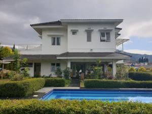 a house with a swimming pool in front of it at Villa Jidah in Gegarbensang +57 photos