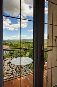 a view from a window of a table on a balcony at La Chaumière, Demeure d'hôtes in Lauris