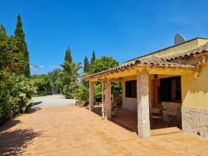 a patio outside of a house with trees at Finca Verde in Llucmajor