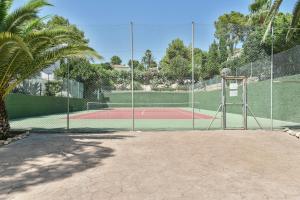 a tennis court with a net on a tennis court at Modern stylish bungalow in Moraira in Moraira