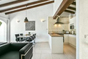 a kitchen and living room with a couch and a table at Modern stylish bungalow in Moraira in Moraira