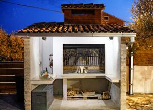 una chimenea en un patio trasero con techo en Villa Mia, en Srima