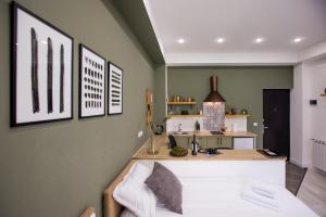 a kitchen with green walls and a counter top at hotelise I Bells-Of-Ireland Apartment in Yerevan