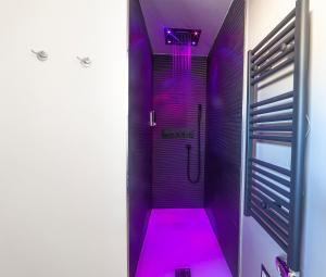 a purple bathroom with a shower with a pink floor at Palazzo Lombardi Al Vicolo in Sassari +73 photos