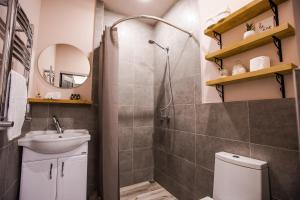 a bathroom with a shower and a sink and a toilet at hotelise I Bells-Of-Ireland Apartment in Yerevan +26 photos