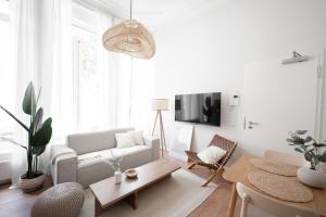 a living room with a couch and a table at Stockholm Style Designer in Limpertsberg in Luxembourg