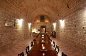 a long dining room with a long table and chairs at Masseria Nucci - Autentica Dimora Storica in Nardò