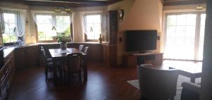 Wynajem Pokoi Osada في فواديسوافوفو: غرفة طعام مع طاولة وتلفزيون