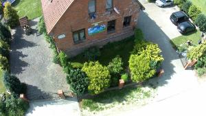 an aerial view of a house with trees in front of it at Chata na końcu świata in Czaplin Mały