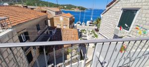 a balcony with a view of a building and the water at Bed & Breakfast Dionis Vis in Vis