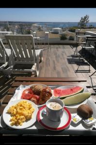 a tray of breakfast food on a table on a roof at Sensations Guesthouse in Lagos