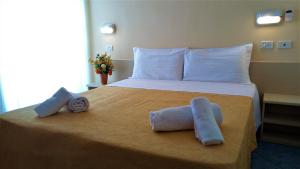Postel nebo postele na pokoji v ubytování Hotel Corona