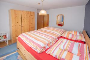 a bedroom with two beds and a mirror at Haus Moselwelt - Tilda in Zell an der Mosel