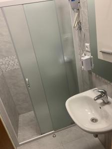 a bathroom with a sink and a shower at Apartmani MM in Starigrad-Paklenica