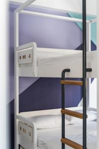 a bunk bed with a ladder in a room at Cocoon City Hostel in Chania