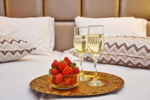 two glasses of champagne and a bowl of strawberries on a table at Villa Marinos in Kavos