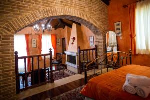 a bedroom with a bed and a brick wall at Acronafplia Pension A in Nafplio