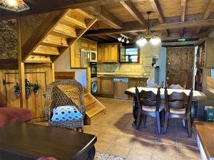 a kitchen and dining room with a table and chairs at La Casina de Orfeo Cuenco Cangas de Onís VV-1901-A in Cangas de Onís