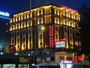 a building with neon signs on the side of it at Green Prusa Hotel in Bursa