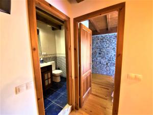 a bathroom with a sink and a toilet and a doorway at La Casina de Orfeo Cuenco Cangas de Onís VV-1901-A in Cangas de Onís +42 photos