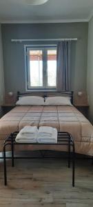 a bed with two towels on it in a bedroom at Villa Bella Vista in Marathias