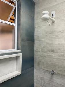 a bathroom with a sink and a mirror on a wall at Hostel Casarão 65 in Salvador +100 photos