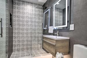 a bathroom with a sink and a mirror at Upscale Home with Hot Tub Walk to Pompano Beach! in Pompano Beach +25 photos
