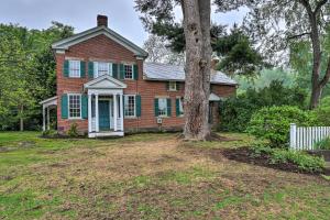 an old brick house with a tree in the yard at Timeless Winesburg House with Private Balcony in Dundee