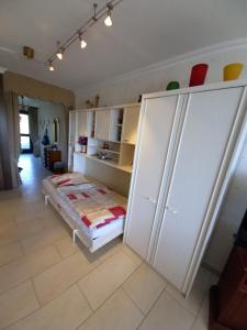 a bedroom with a bed and a large white closet at Seeappartement Sorpeglück in Sundern