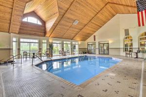 a large indoor swimming pool with a wooden ceiling at Lakefront Birchwood Condo with Pool and Hot Tub! in Birchwood