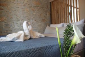 a person is laying on a bed with towels at Laini Guest Houses in Koulkouthianá