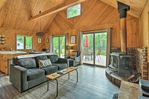 a living room with a couch and a stove at Riverfront Traverse City Cabin Fish, Kayak and Tube in Traverse City