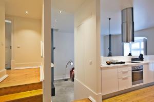 a kitchen with white cabinets and a stove at Lisbon Canaan Boutique Apartments Gaivotas by Get Your Stay in Lisbon +175 photos