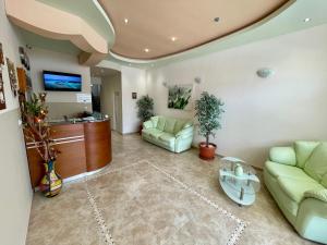 a living room with a couch and a table at Family Hotel Avenue  in Kiten