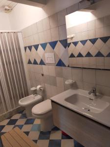 a bathroom with a toilet and a sink and a mirror at Hotel all'Antico Pozzo in Barcellona-Pozzo di Gotto