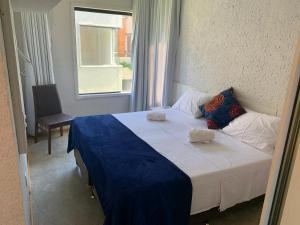 a bedroom with a large bed with a window at Vila dos Milagres Casa de Charme in São Miguel dos Milagres