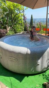 una joven está en una gran piscina circular en Residenza Buggiano Antica B&B - Charme Apartment in Tuscany, en Borgo a Buggiano