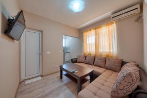 a living room with a couch and a table at XXL Apartments in Dobra Voda