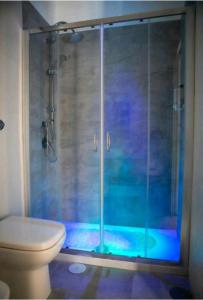 a bathroom with a glass shower with a toilet at Brighter's Room in Naples