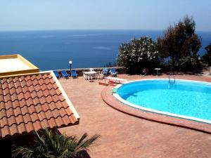 a swimming pool with a view of the ocean at Residence Covo degli Dei in Milazzo