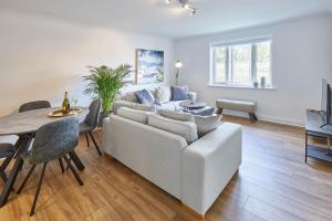 a living room with a couch and a table at Host & Stay - Freshwater View in Whitby