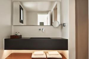 a bathroom with a black sink and a mirror at Orama Hotel & Spa in Fira