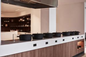 a kitchen with pots and pans on a counter at Orama Hotel & Spa in Fira